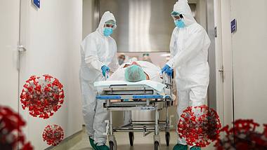 Corona-Patient im Krankenhaus mit Ärzten - Foto: iStock/Tempura
