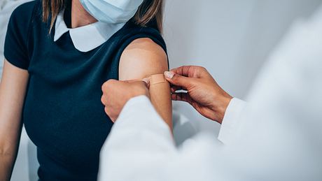 Arzt bringt Pflaster nach Impfung an - Foto: iStock/VioletaStoimenova