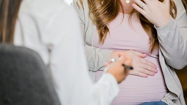 Schwangere Frau im Gespräch mit einer Doula. - Foto: iStock/ Courtney Hale