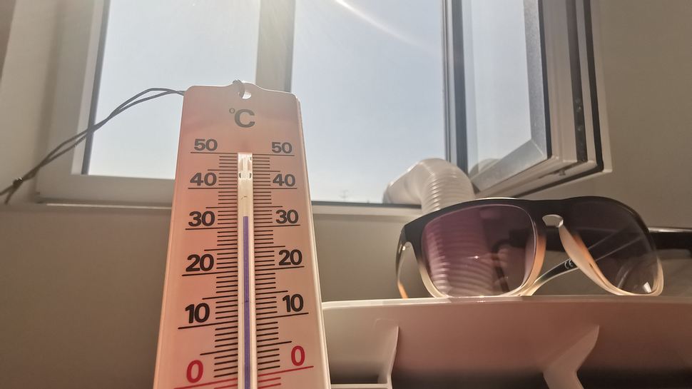 Thermometer und Sonnenbrille liegen vor offenem Fenster - Foto: iStock/RR-Photos