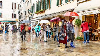 Menschen mit Atemmaske gehen durch die Einkaufsstraße - Foto: istock/Alphotographic