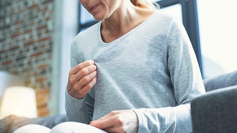 Frau schwitzt übermäßig. - Foto: iStock/yacobchuk