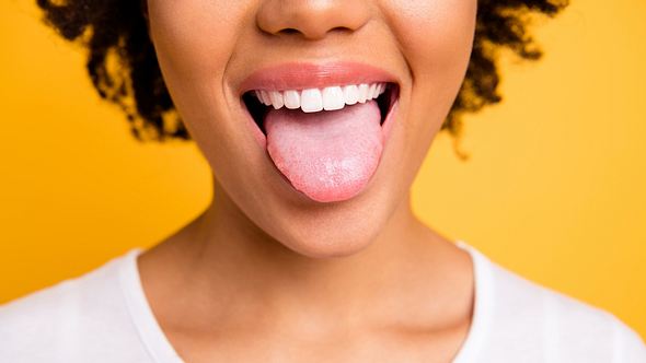 Frau streckt die Zunge raus - Foto: Istock/Deagreez